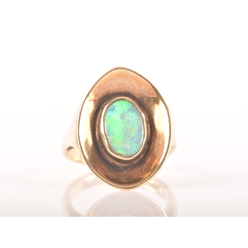 91 - A 9ct yellow gold dress ring with a concave oval design, set to centre with a opal measuring approxi... 