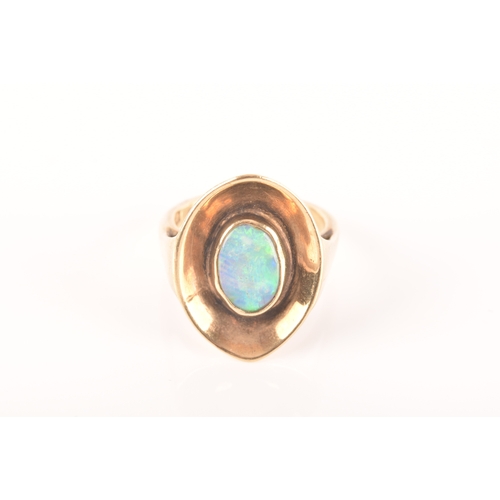 91 - A 9ct yellow gold dress ring with a concave oval design, set to centre with a opal measuring approxi... 