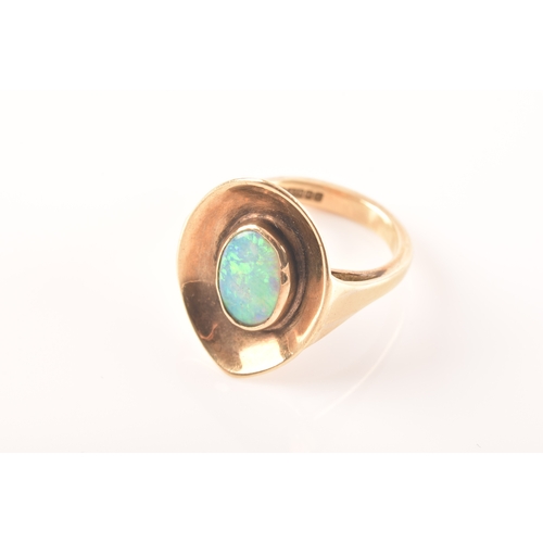 91 - A 9ct yellow gold dress ring with a concave oval design, set to centre with a opal measuring approxi... 