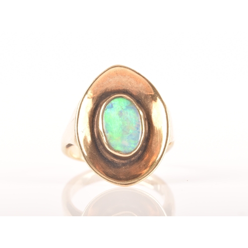 91 - A 9ct yellow gold dress ring with a concave oval design, set to centre with a opal measuring approxi... 