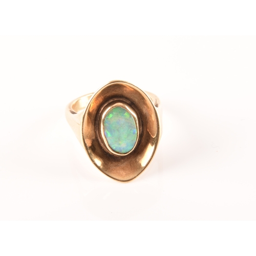 91 - A 9ct yellow gold dress ring with a concave oval design, set to centre with a opal measuring approxi... 