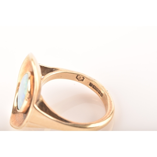 91 - A 9ct yellow gold dress ring with a concave oval design, set to centre with a opal measuring approxi... 