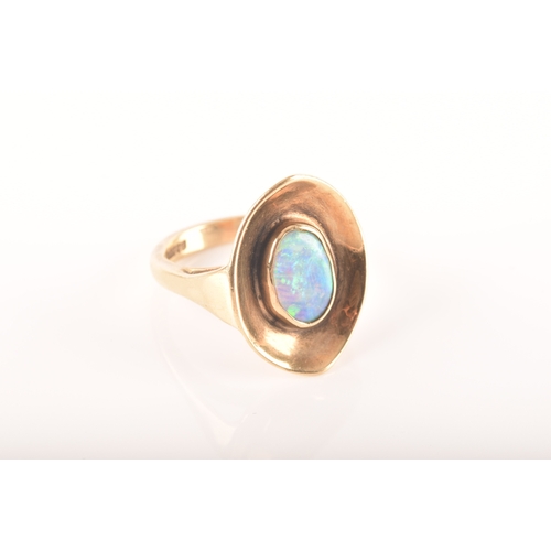 91 - A 9ct yellow gold dress ring with a concave oval design, set to centre with a opal measuring approxi... 