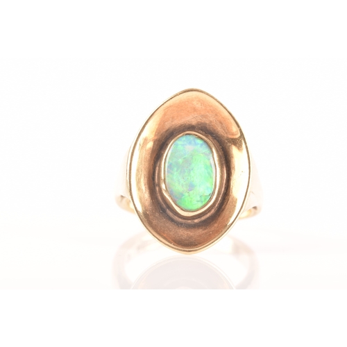 91 - A 9ct yellow gold dress ring with a concave oval design, set to centre with a opal measuring approxi... 