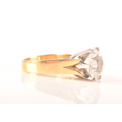 14 - An 18ct yellow gold solitaire ring set with a round cut synthetic white sapphire with an approximate... 