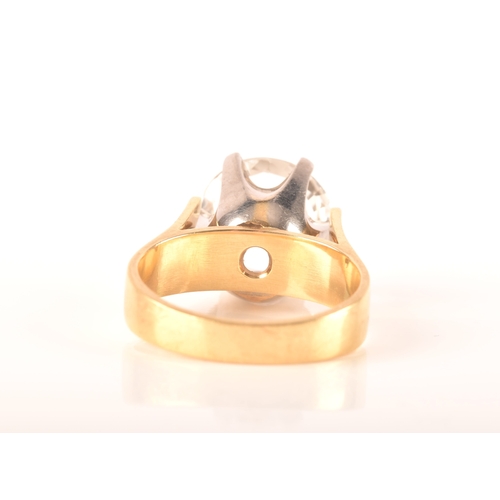 14 - An 18ct yellow gold solitaire ring set with a round cut synthetic white sapphire with an approximate... 