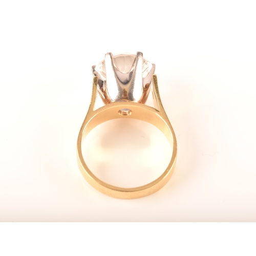 14 - An 18ct yellow gold solitaire ring set with a round cut synthetic white sapphire with an approximate... 