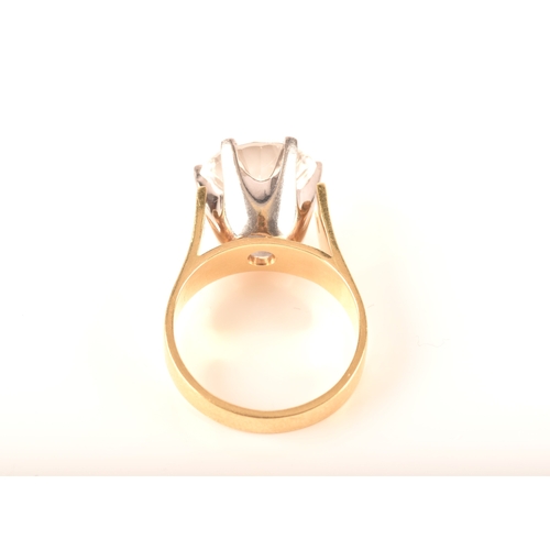 14 - An 18ct yellow gold solitaire ring set with a round cut synthetic white sapphire with an approximate... 