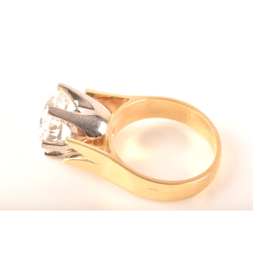 14 - An 18ct yellow gold solitaire ring set with a round cut synthetic white sapphire with an approximate... 