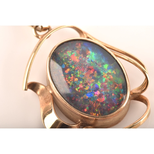 96 - A 9ct yellow gold pendant, set with a oval cabochon opal triplet measuring approximately 16 x 12mm.