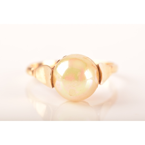 57 - A yellow metal ring, set to centre with a round cultured pearl measuring approximately 8.5mm, with u... 