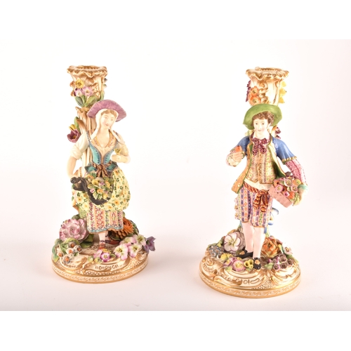 316 - A pair of 19th century porcelain figural candlesticks, possibly Derby, with Savoyard figures of male... 