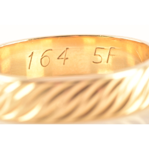 56 - An 18ct gold wedding band, hallmarked for London 1982 by Slade & Woolf Ltd, with wave design eng... 