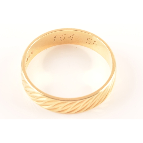 56 - An 18ct gold wedding band, hallmarked for London 1982 by Slade & Woolf Ltd, with wave design eng... 