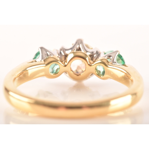 42 - A diamond and emerald three stone ring, set to centre with a cushion shape old mine diamond with an ... 