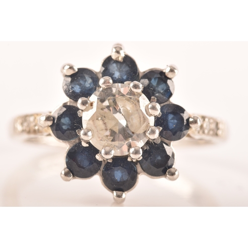 43 - A platinum diamond and sapphire coronet cluster, set to centre with a round brilliant cut diamond wi... 