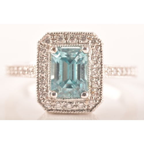 44 - An 18ct white gold aquamarine and diamond dress ring, set to centre with a rectangular aquamarine wi... 