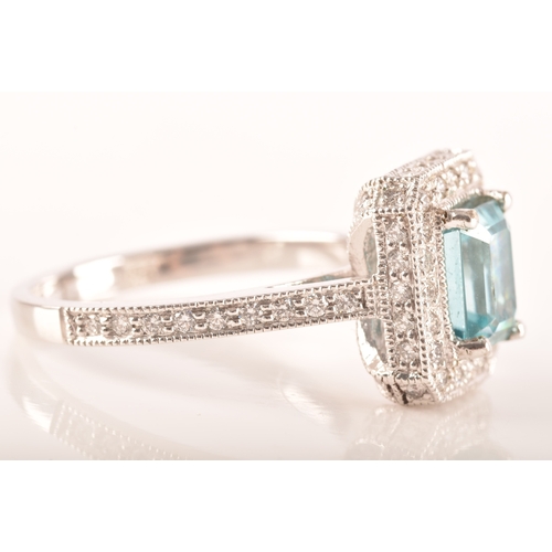 44 - An 18ct white gold aquamarine and diamond dress ring, set to centre with a rectangular aquamarine wi... 