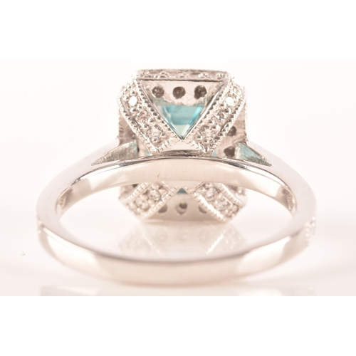 44 - An 18ct white gold aquamarine and diamond dress ring, set to centre with a rectangular aquamarine wi... 