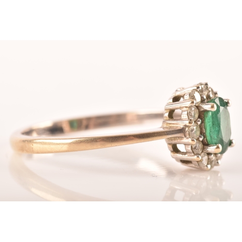 87 - An 18ct white gold emerald and diamond oval coronet cluster, set with centre with an oval emerald wi... 