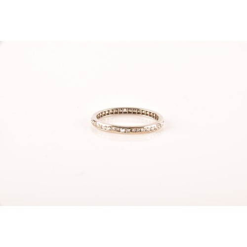 62 - A diamond and white metal eternity ring, channel-set with small eight-cut diamonds, band width 2.1 m... 