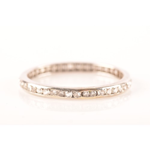 62 - A diamond and white metal eternity ring, channel-set with small eight-cut diamonds, band width 2.1 m... 