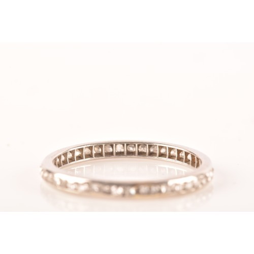 62 - A diamond and white metal eternity ring, channel-set with small eight-cut diamonds, band width 2.1 m... 