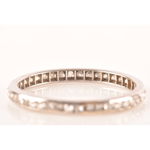 62 - A diamond and white metal eternity ring, channel-set with small eight-cut diamonds, band width 2.1 m... 