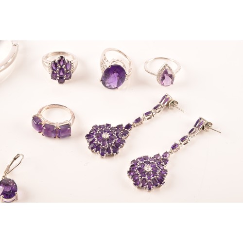 108 - A large collection of silver amethyst jewellery, including a large solitaire dress ring, a floral cl... 