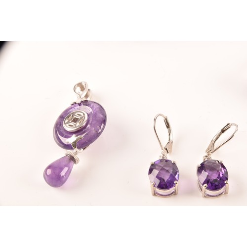 108 - A large collection of silver amethyst jewellery, including a large solitaire dress ring, a floral cl... 