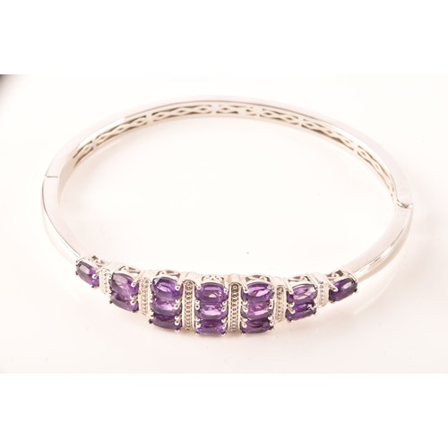 108 - A large collection of silver amethyst jewellery, including a large solitaire dress ring, a floral cl... 