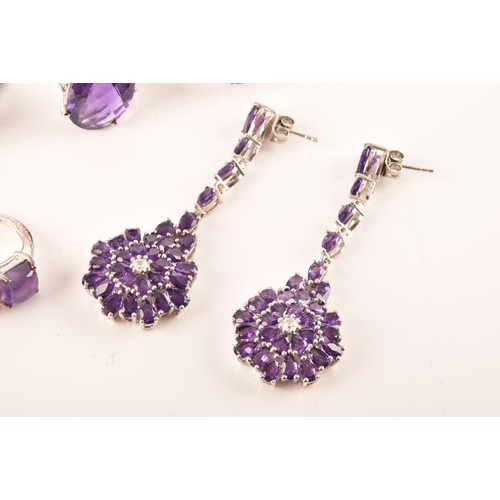 108 - A large collection of silver amethyst jewellery, including a large solitaire dress ring, a floral cl... 