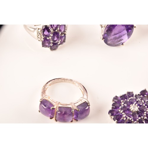 108 - A large collection of silver amethyst jewellery, including a large solitaire dress ring, a floral cl... 