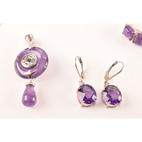 108 - A large collection of silver amethyst jewellery, including a large solitaire dress ring, a floral cl... 