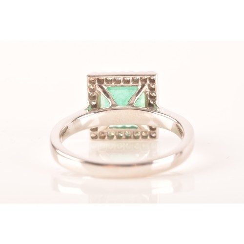 47 - A 18ct white gold emerald and diamond ring, set to centre with a hexagonal cut emerald with an appro... 