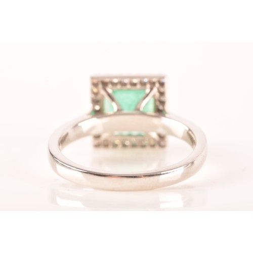 47 - A 18ct white gold emerald and diamond ring, set to centre with a hexagonal cut emerald with an appro... 