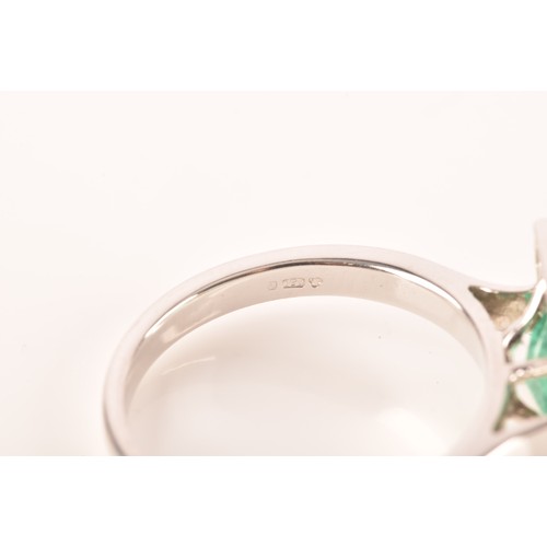 47 - A 18ct white gold emerald and diamond ring, set to centre with a hexagonal cut emerald with an appro... 