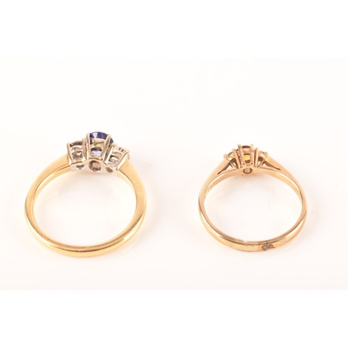 48 - An 18ct yellow gold sapphire and diamond three stone ring, set to centre with a oval cut sapphire wi... 