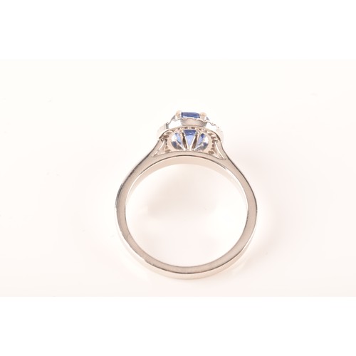 49 - An 18ct white gold sapphire and diamond oval cluster, set to centre with a oval cut blue sapphire wi... 