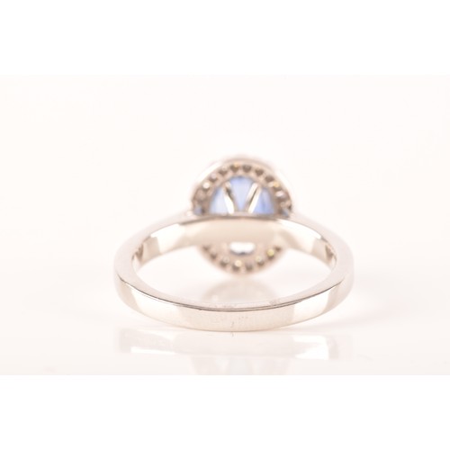 49 - An 18ct white gold sapphire and diamond oval cluster, set to centre with a oval cut blue sapphire wi... 