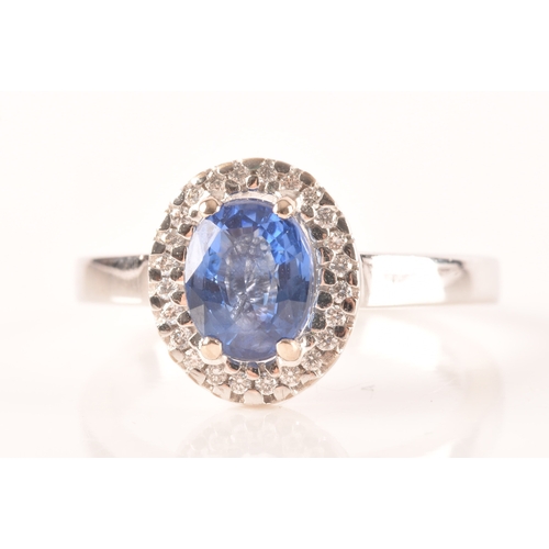 49 - An 18ct white gold sapphire and diamond oval cluster, set to centre with a oval cut blue sapphire wi... 