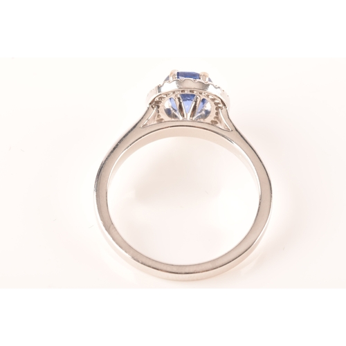 49 - An 18ct white gold sapphire and diamond oval cluster, set to centre with a oval cut blue sapphire wi... 