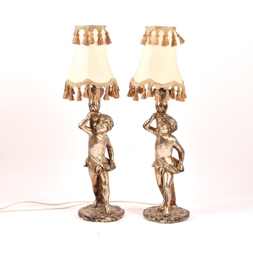 385 - A pair of decorative silvered cherub table lamps, plaster formed as cherubs holding aloft sconces, 6... 