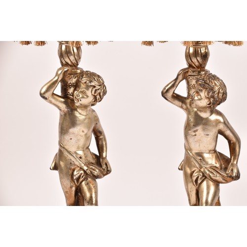 385 - A pair of decorative silvered cherub table lamps, plaster formed as cherubs holding aloft sconces, 6... 