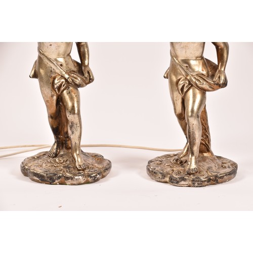 385 - A pair of decorative silvered cherub table lamps, plaster formed as cherubs holding aloft sconces, 6... 