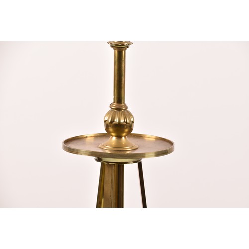 387 - A Victorian style brass standard lamp, with shaped arms, circular mid-level shelf, supported on a tr... 