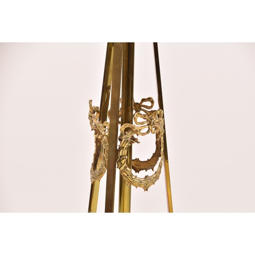 387 - A Victorian style brass standard lamp, with shaped arms, circular mid-level shelf, supported on a tr... 