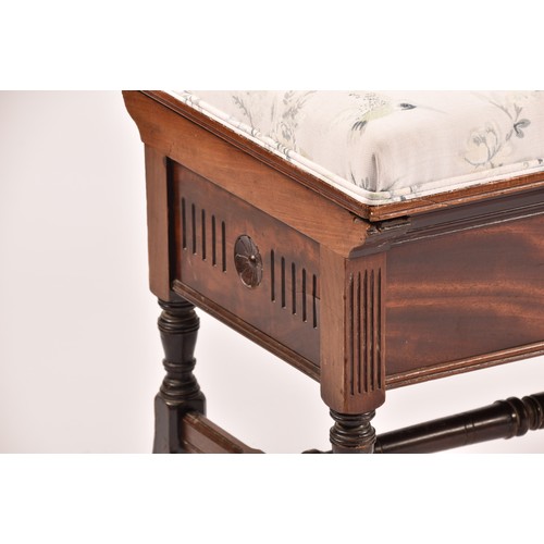 388 - An Edwardian mahogany duet piano stool, with hinged lid, upholstered in peacock fabric, with turned ... 