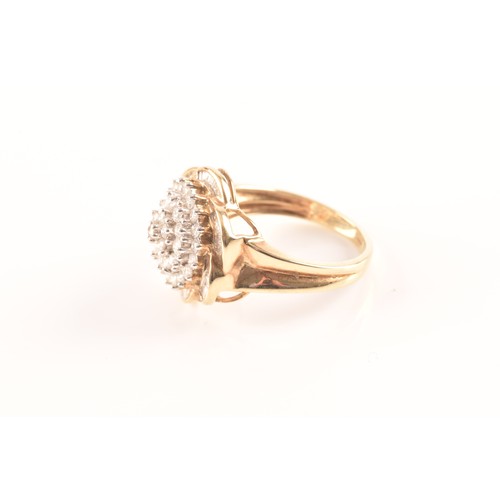 55 - A 9ct yellow gold diamond flower cluster ring, featuring a myriad of brilliant cut diamonds, further... 