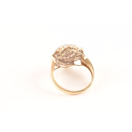 55 - A 9ct yellow gold diamond flower cluster ring, featuring a myriad of brilliant cut diamonds, further... 